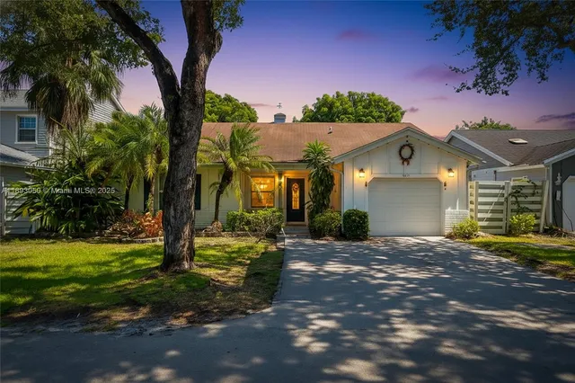 a view of a house with a tree in a yard