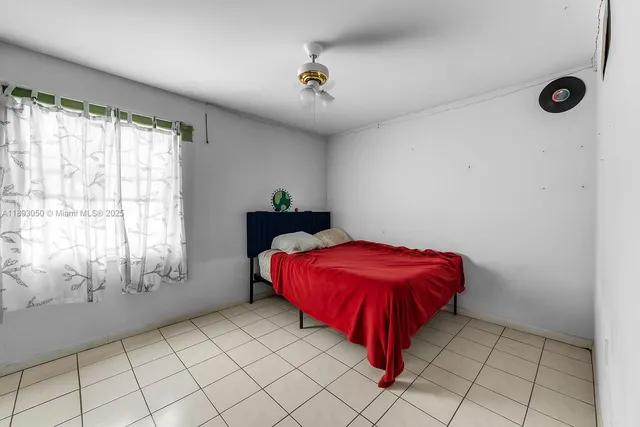 a spacious bedroom with a bed and a window