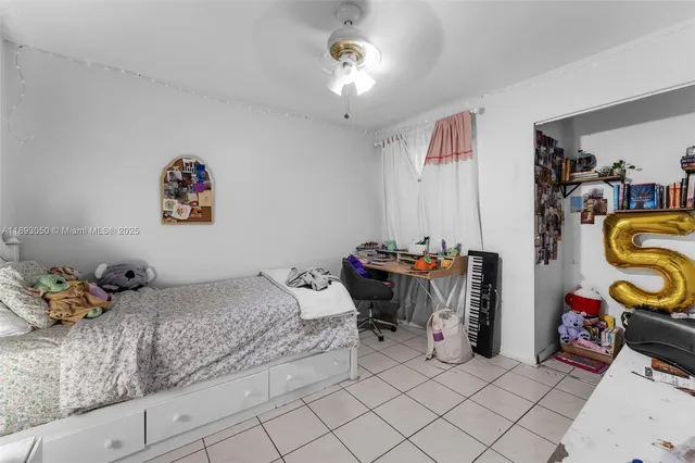 a bedroom with bed and a chandelier
