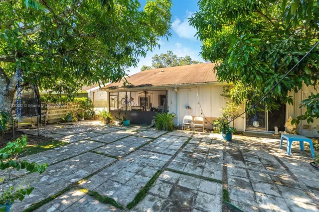 a view of a patio with table and chairs and potted plants