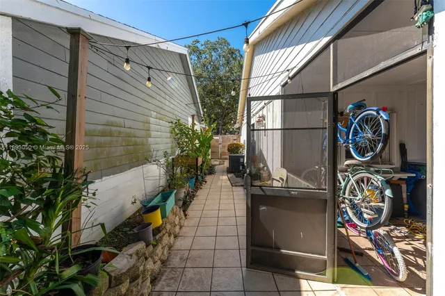 a view of a street with potted plants