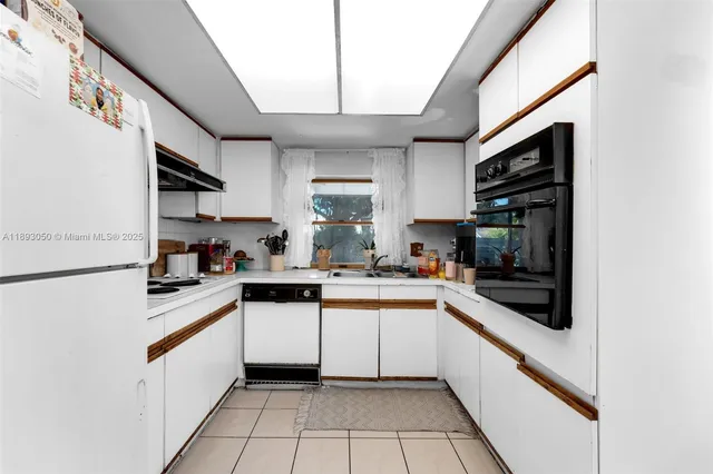 a kitchen with a sink cabinets and stainless steel appliances