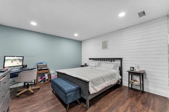 a bedroom with a bed a desk and chair