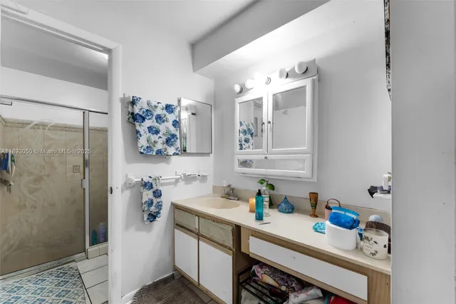 a bathroom with a tub sink and glass door