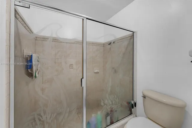 a bathroom with a shower and toilet