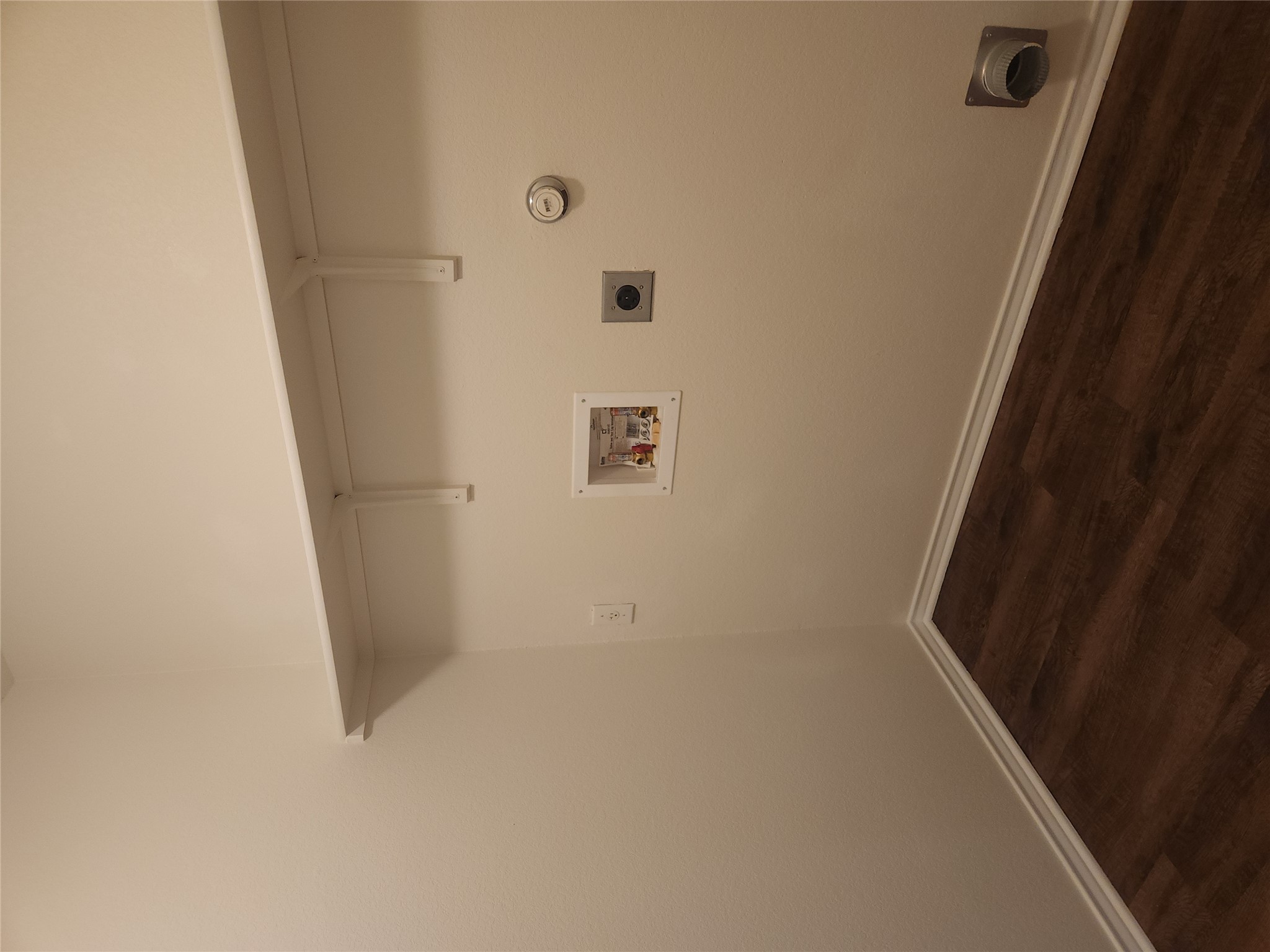 160 Rummel Drive Kyle, TX 78640 - Photo 12 of 13 A dedicated utility space with robust wood flooring and ample shelving provides practical living.