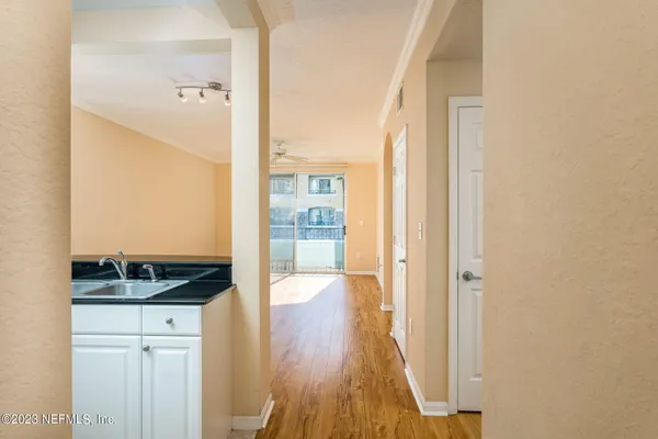 a kitchen with a window and wooden floor