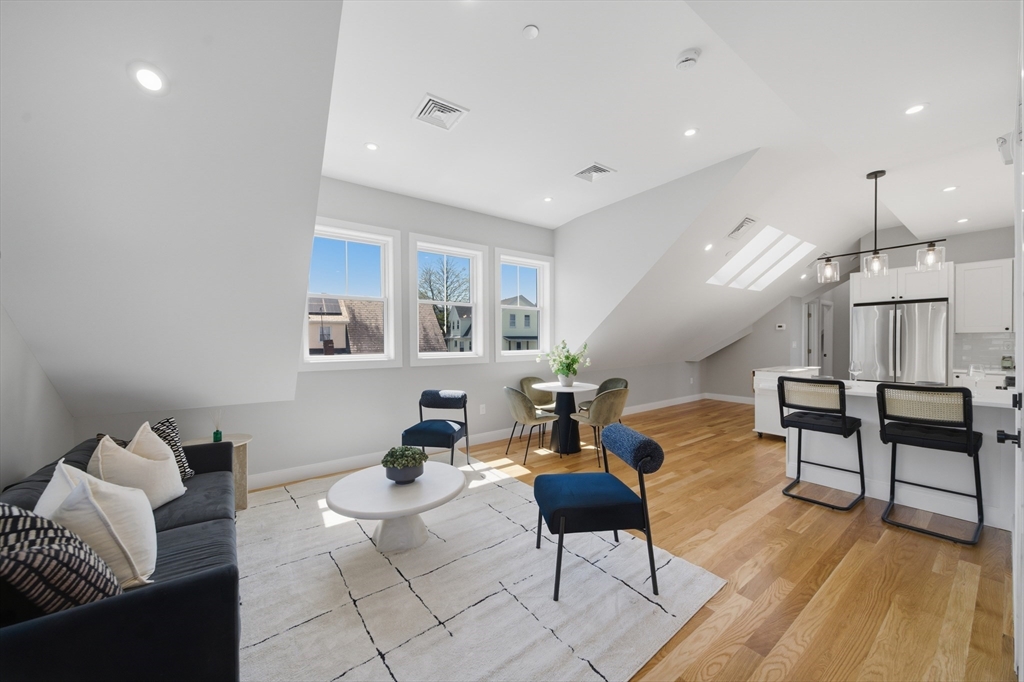 174 Walnut Street, Unit 3 Somerville, MA 02145 - Photo 2 of 38 a living room with furniture and wooden floor