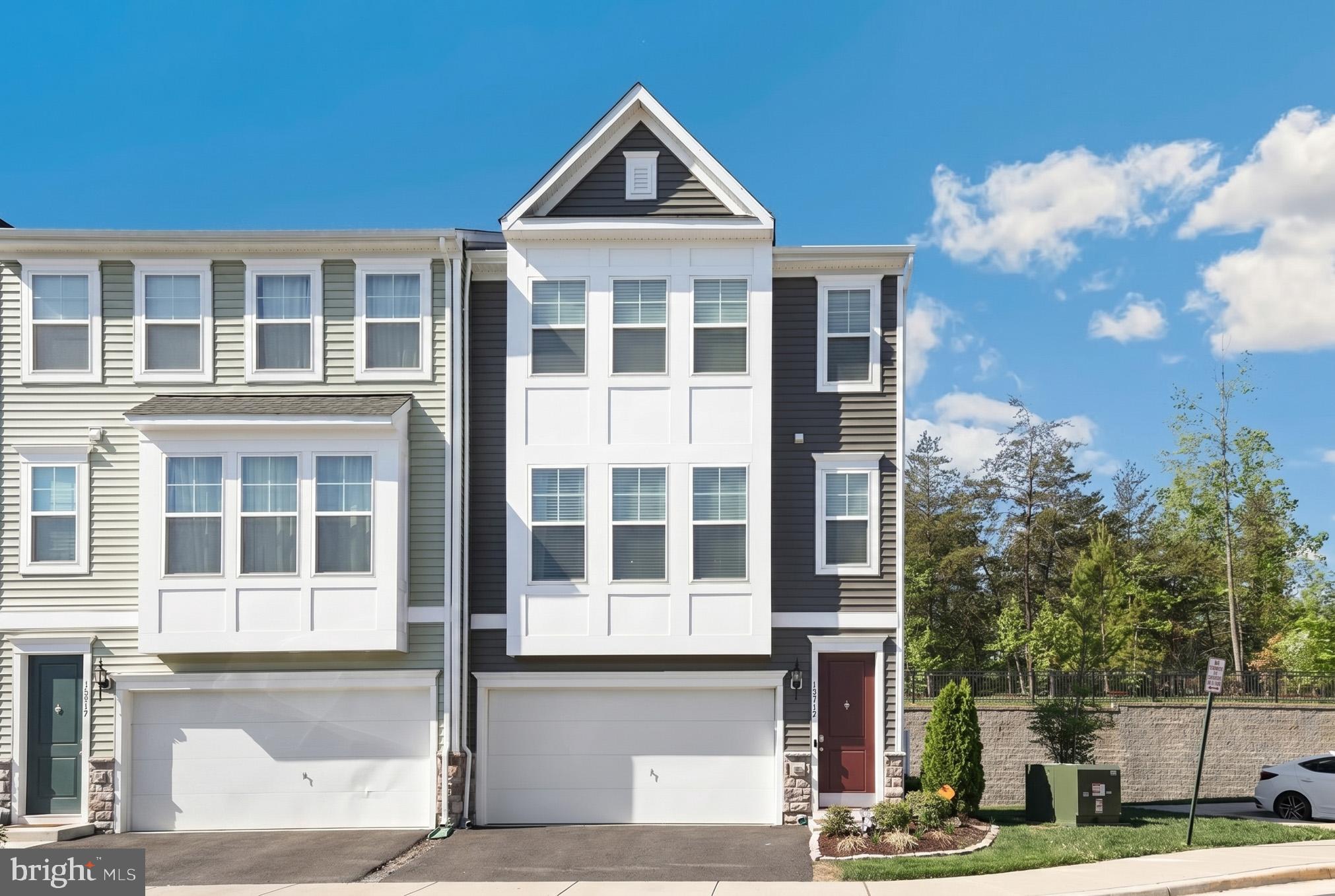 18319 Summit Pointe Drive Triangle, VA 22172 - Photo 1 of 40 a front view of a building with a yard