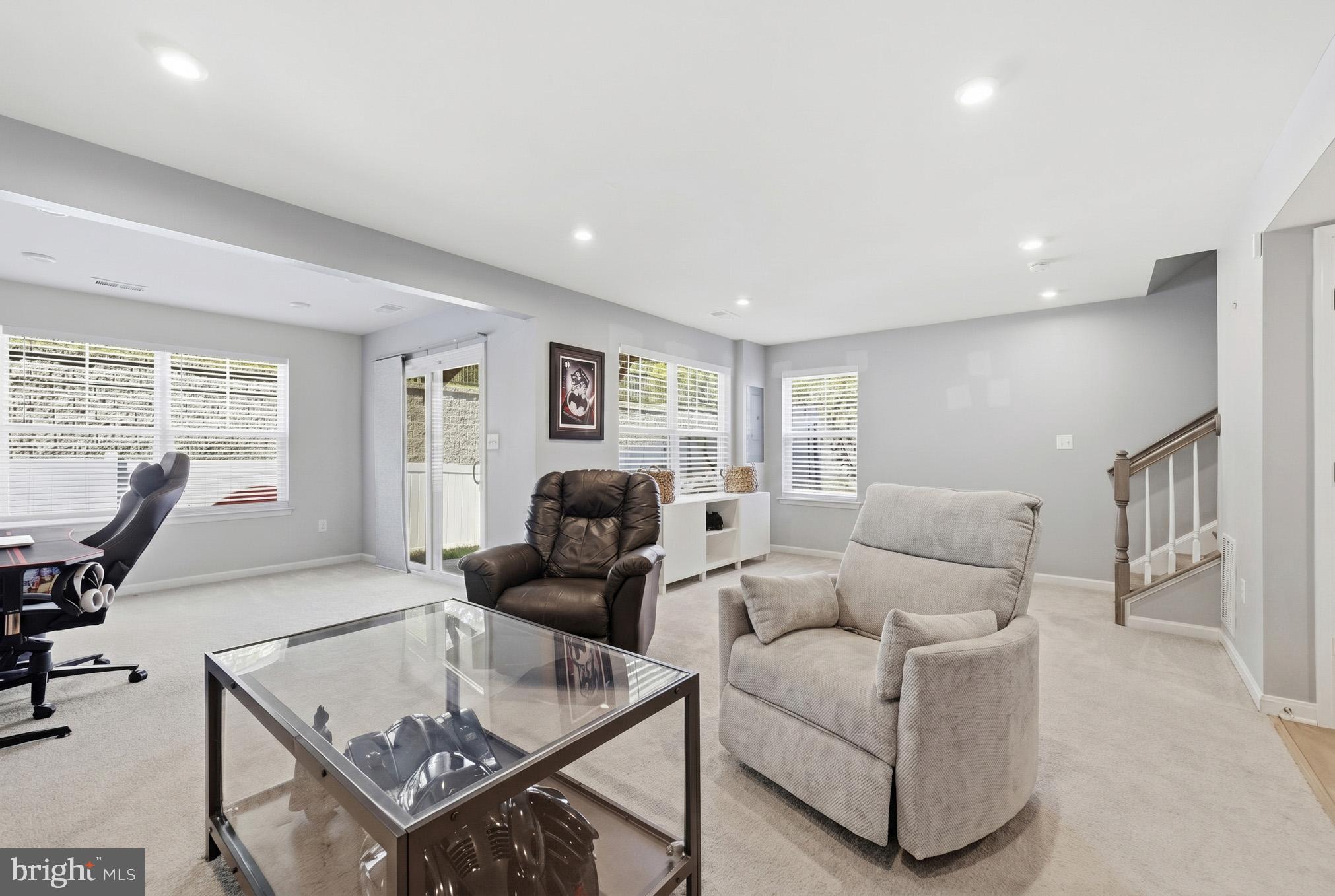 18319 Summit Pointe Drive Triangle, VA 22172 - Photo 33 of 40 a living room with furniture a large window and a flat screen tv