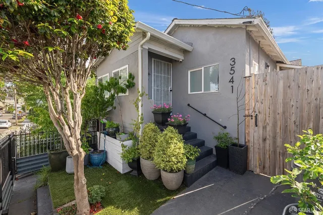 a front view of a house with a garden