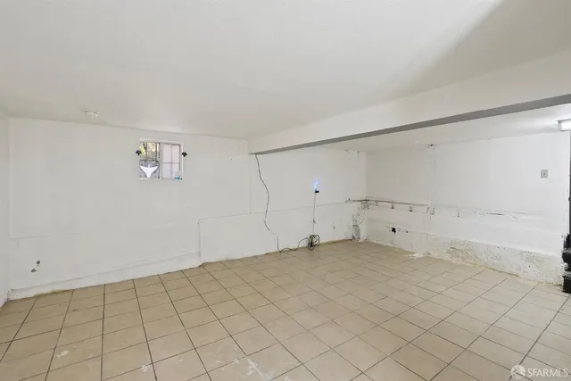 a view of a patio with chairs and table under an umbrella