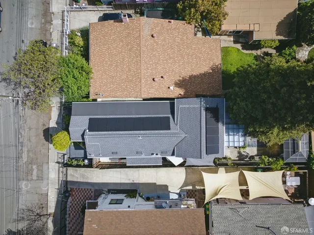 an aerial view of a house with a yard and lake view