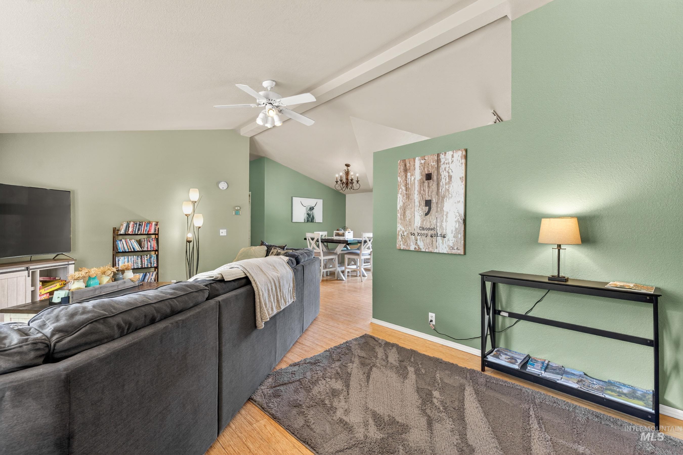 151 Cow Creek Road Lucile, ID 83542 - Photo 10 of 50 Expansive living area featuring vaulted ceilings, wood-finish flooring, and a ceiling fan with integrated lighting