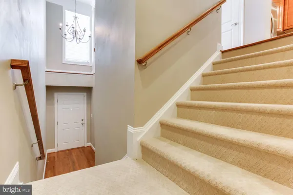 a view of staircase with white walls and railing
