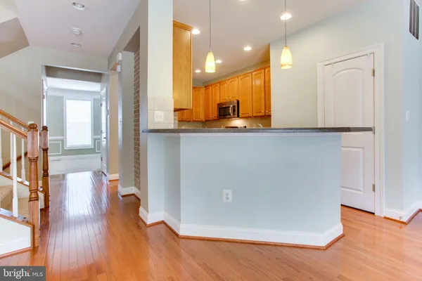 a view of kitchen with furniture and wooden floor
