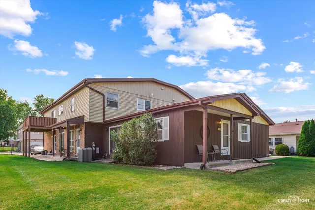 a front view of a house with a yard and porch