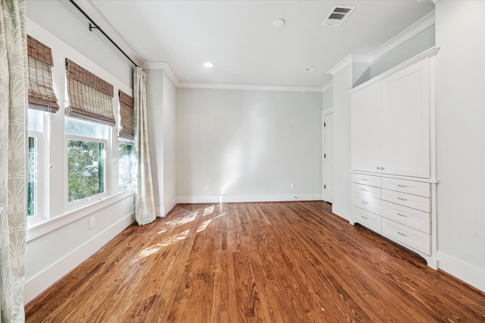 1506 Indiana Street Houston, TX 77006 - Photo 28 of 37 a view of an empty room with wooden floor and a window