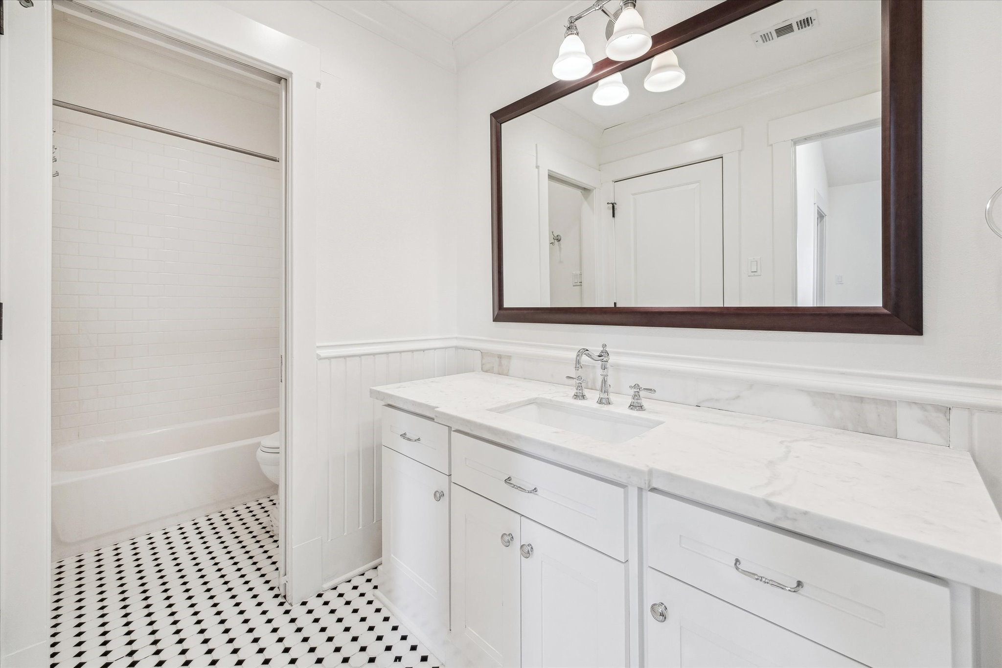 1506 Indiana Street Houston, TX 77006 - Photo 29 of 37 a bathroom with a sink a vanity and a mirror