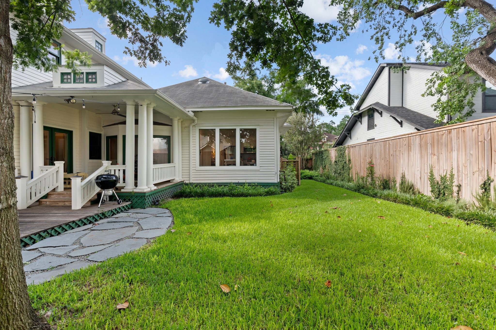 1506 Indiana Street Houston, TX 77006 - Photo 34 of 37 This home not only has a generously sized front yard, but a spacious and beautifully landscaped backyard with a covered patio, outdoor dining patio, and generous grassy area.
