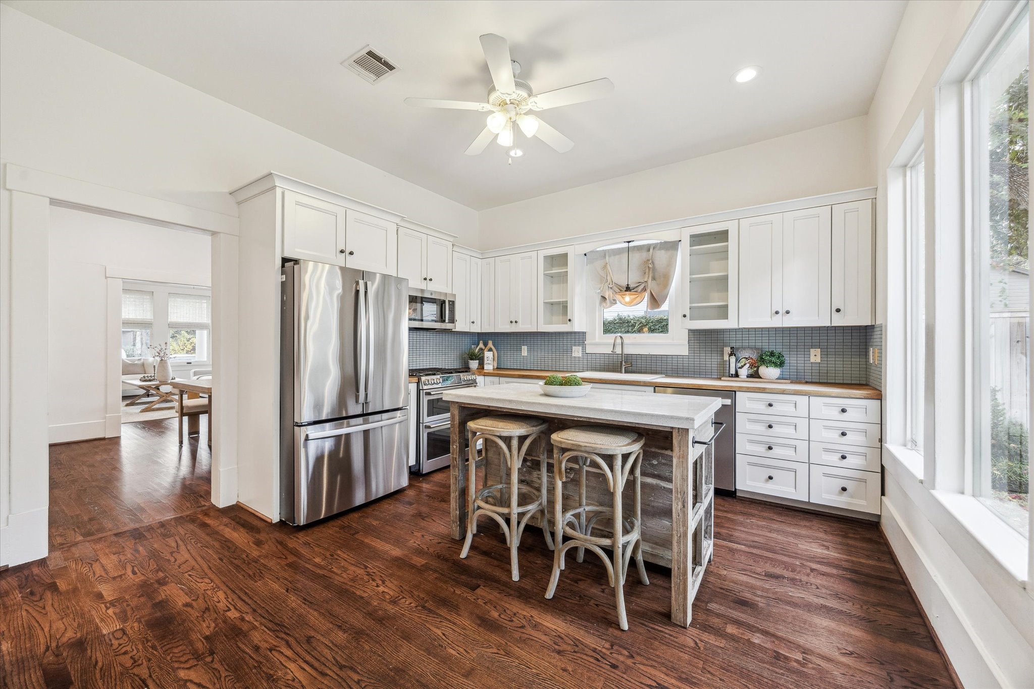 1506 Indiana Street Houston, TX 77006 - Photo 10 of 37 a kitchen with stainless steel appliances a dining table chairs refrigerator and cabinets