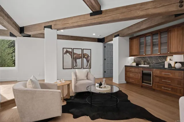 a living room with furniture and a kitchen area