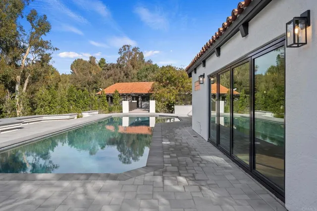 a view of a swimming pool with a patio