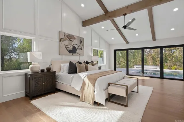 a spacious bedroom with a large bed and a large window