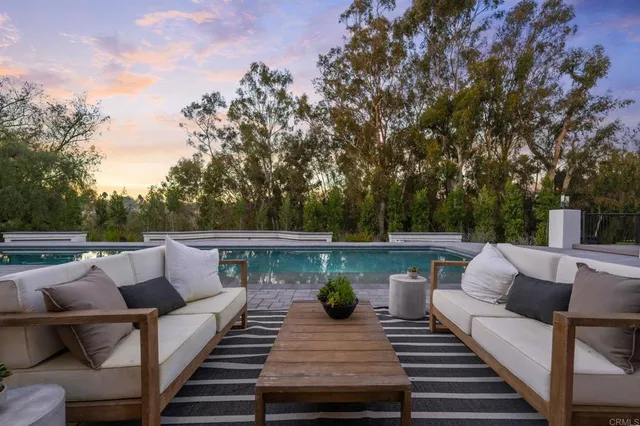 a view of balcony with wooden floor and seating space