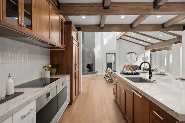 a kitchen with stainless steel appliances granite countertop a sink and stove