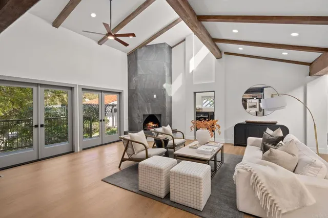 a living room with furniture and a floor to ceiling window