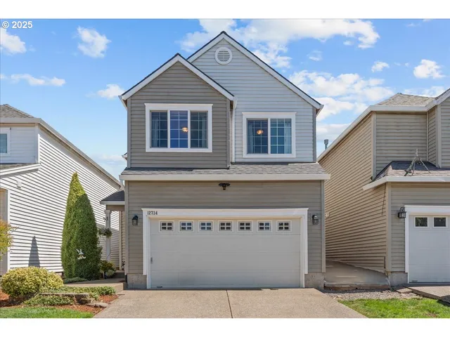 a view of a house with a yard and potted plants