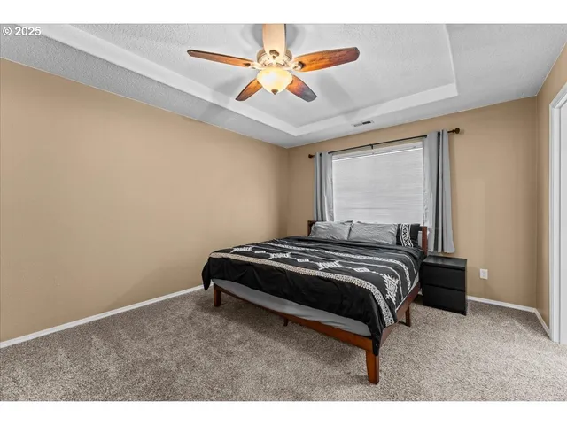 a view of bedroom with ceiling fan