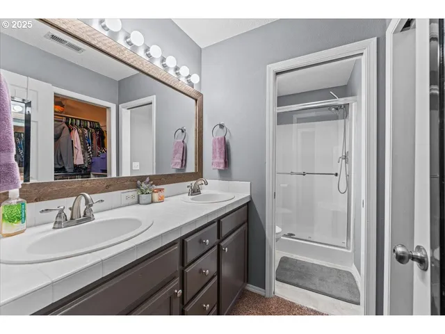 a bathroom with a shower and a sink