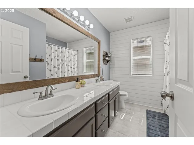 a bathroom with a shower curtain and a sink