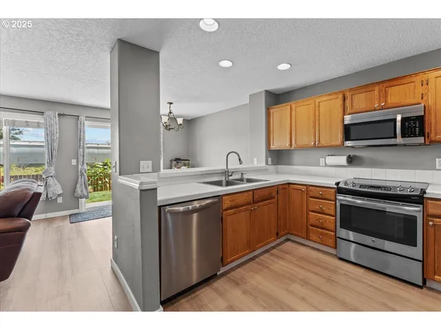 a view of a dining room with furniture wooden floor and a chandelier