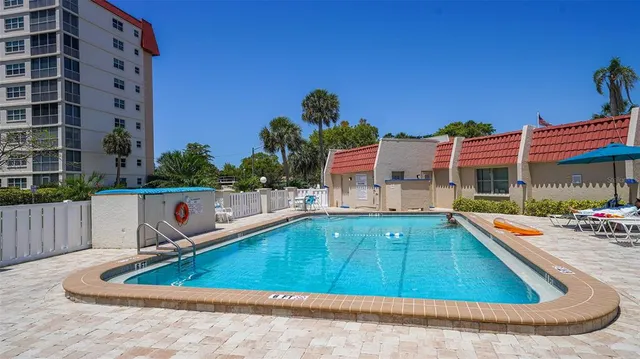 a view of a house with swimming pool and sitting area