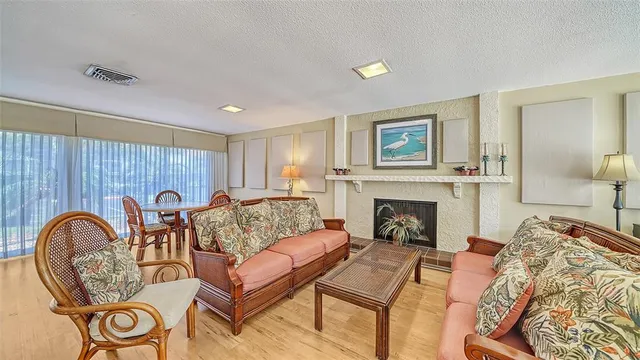 a living room with furniture a fireplace and window
