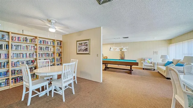 a reading room with furniture and a book shelf