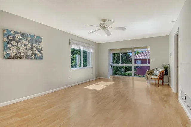 a view of a livingroom with a lounge chair and a large window