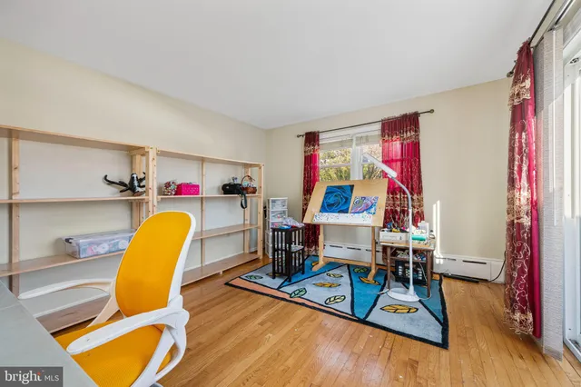 a view of a room with furniture and wooden floor