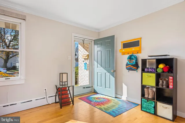 a living room with furniture and a baby crib