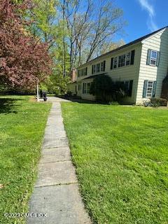 23 Copper Beech Road Greenwich, CT 06830 - Photo 12 of 15 a front view of a house with a yard