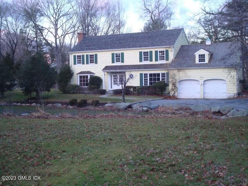 23 Copper Beech Road Greenwich, CT 06830 - Photo 2 of 15 a front view of a house with yard and green space