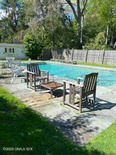 23 Copper Beech Road Greenwich, CT 06830 - Photo 4 of 15 a view of a slide with table and chairs in the patio