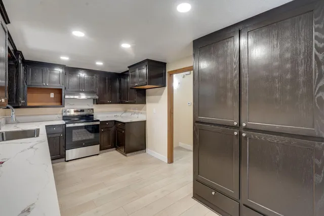 a kitchen with a refrigerator and a sink