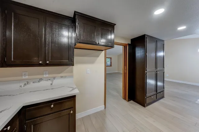 a view of a refrigerator in kitchen and wooden floor