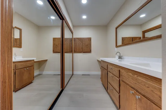 a bathroom with a sink a double vanity and a large mirror