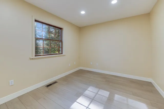 an empty room with windows and closet