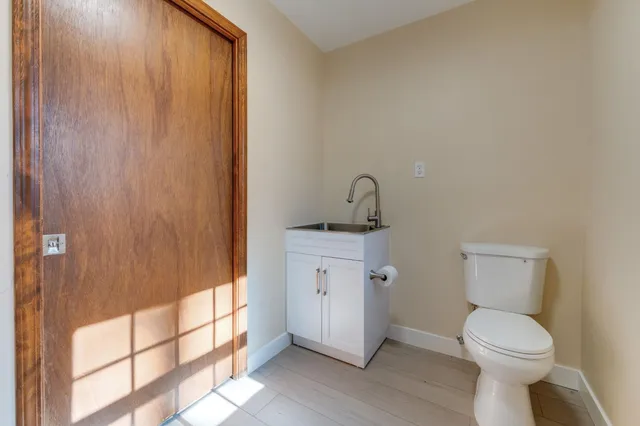 a bathroom with a toilet a sink and shower